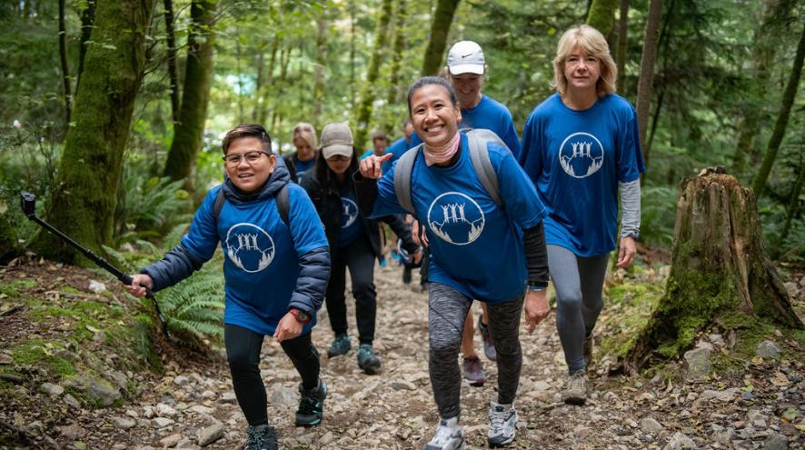 Hikers smiling as they climb Grouse Mountain in the Climb for Alzheimer's 2019.