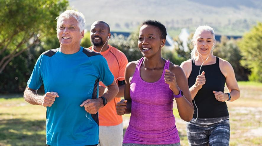 Four people jogging together.