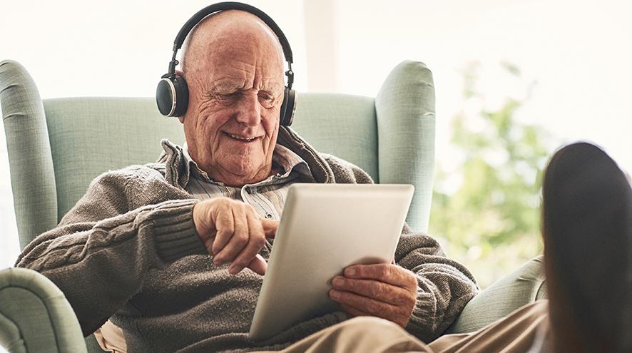 Senior man watching a video on his tablet.