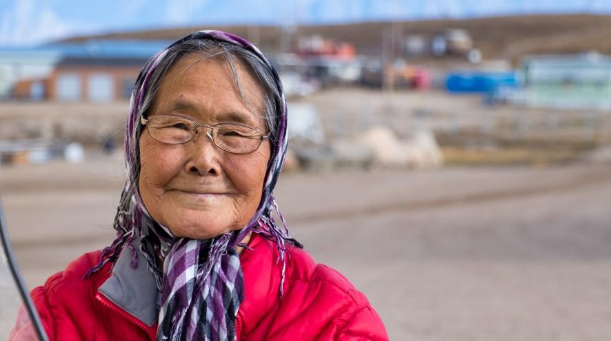 Senior woman standing in front of her town.