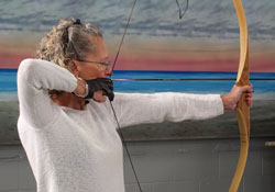 Phyllis taking aim with her bow.