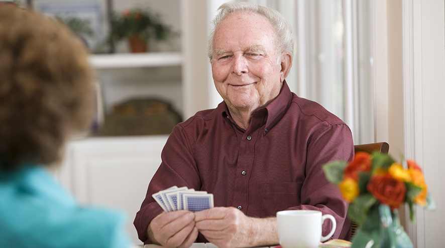 Senior man playing cards.