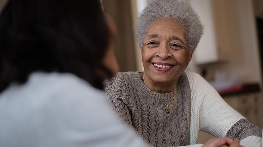 Smiling senior woman talking to her doctor.