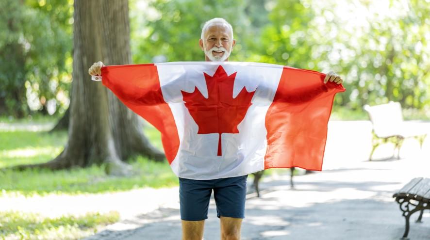 Senior man holding the Canadian flag