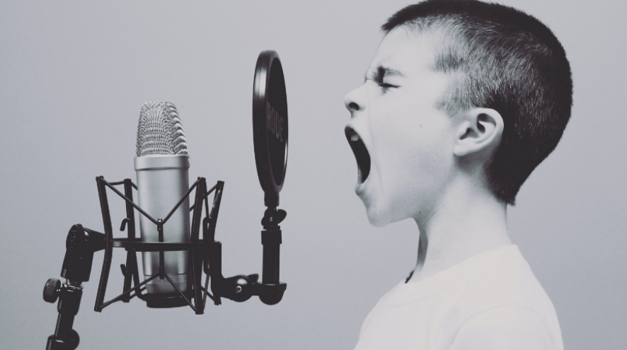 White boy shouting into a microphone